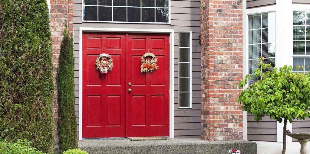 Large red door with grand entrance in a big house Front Doors - Interior Door Replacement Company